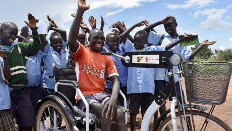 Moses Oriam with peers after receiving his tricycle through education can not wait project from light for the world and save the children in Eastern Equatoria 